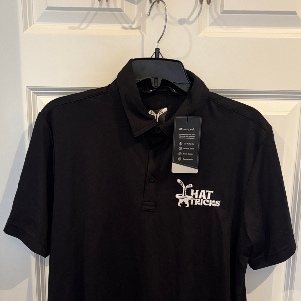 Travis Mathew Black Polo with White Hat Tricks Logo